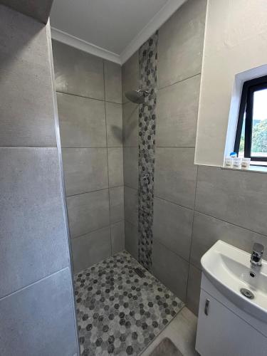 a bathroom with a shower and a sink at Levangrey in George