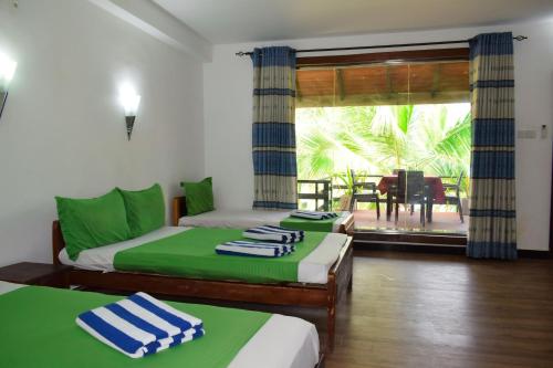 Postel nebo postele na pokoji v ubytování Hotel Green Garden