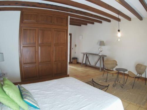 a bedroom with a bed and a wooden closet at Rural Rugama in Puerto del Rosario