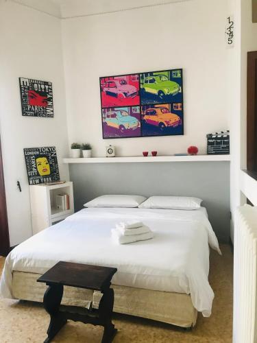 a bedroom with a bed and a painting on the wall at Donna Franca in Lecce