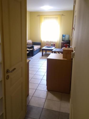 a room with a kitchen and a living room at Derveni Seaside Apartments - Deluxe Sea View Penthouse Jacuzzi-BBQ & Groundfloor Garden View Apartment in Derveni
