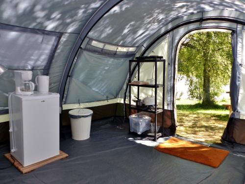 a tent with a shelf inside of it at Domaine du Balbuzard in Condat-en-Combraille
