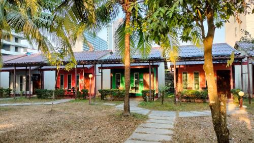 a house with palm trees in front of it at Twin Palms Resort in Sihanoukville