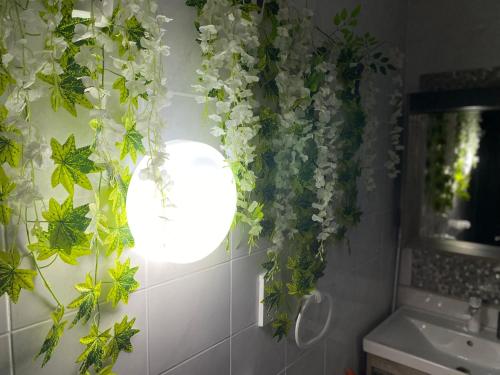 a bathroom with a bunch of flowers on the wall at Sea Breeze Retreat - Comfort Apartments in the Heart of Sliema in Sliema