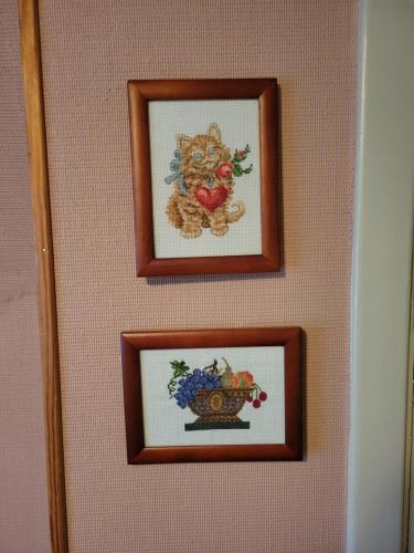 two framed pictures hanging on a wall at Mysigt rum med lantligt läge i privat bostad med katter in Storå