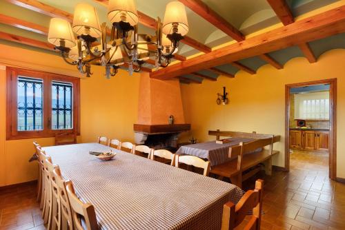 a dining room with a table and chairs and a dining room at Casanova de Noet in Aviá