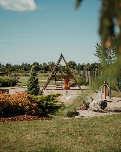 a playground with a wooden frame in a park at Zeltāres in Jelgava