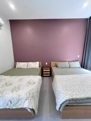 Postel nebo postele na pokoji v ubytování Nguyễn Tân Homestay Near Beach BBQ Free Mỹ Tân