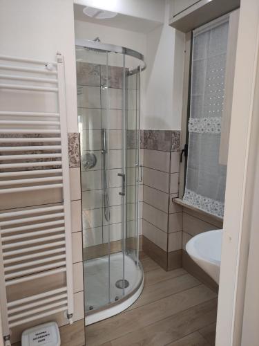 a bathroom with a glass shower and a sink at Casa Manu Affittacamere in Arezzo