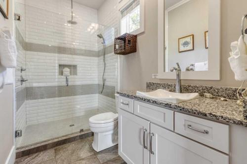 a bathroom with a shower and a toilet and a sink at Modern Coastal Escape Near 30A - Inlet Beach in Inlet Beach