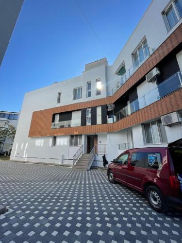 a red van parked in front of a building at Cozy Nest by the Sea in Draçi