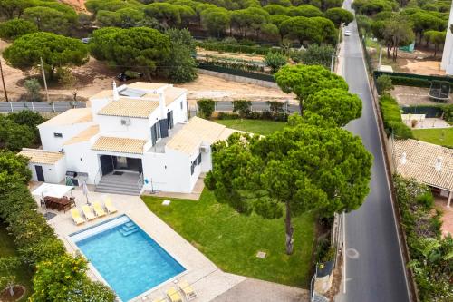 an aerial view of a house with a swimming pool at Casa Da Laranjeira- Serene 4Bedroom 4Bath Pool & Garden Villa, 10 mins to Vilamoura Marina in Quarteira