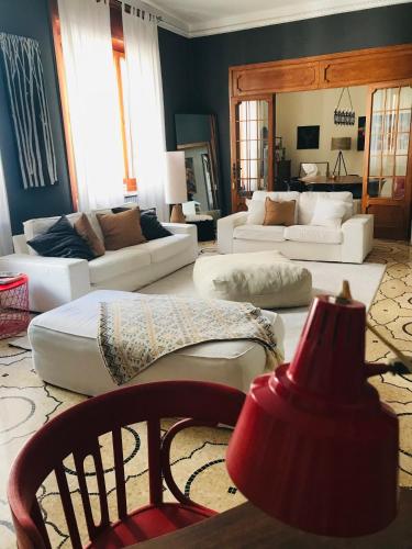 a living room with white couches and a red lamp at Donna Franca in Lecce