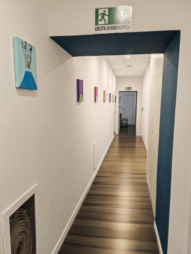 a hallway with white walls and wood floors at Art Street Hotel in Naples