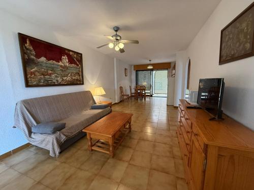 a living room with a couch and a tv at Marco Polo by Alina365 in La Manga del Mar Menor