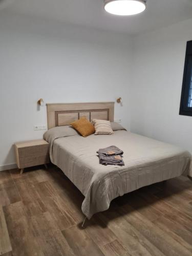 a bedroom with a large bed with a wooden floor at Villa Ainara Aguadulce in Aguadulce