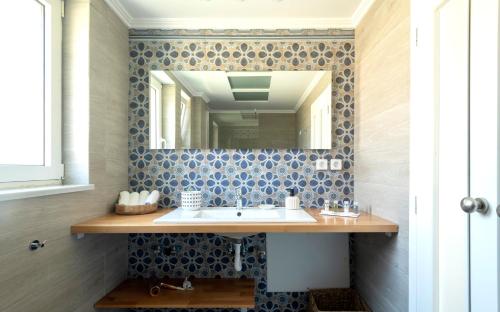 a bathroom with a sink and a mirror at ALMA HILLS Gialova in Gialova