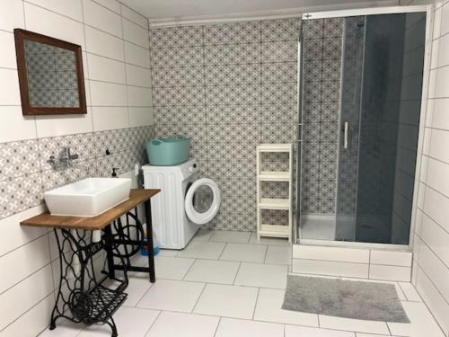 a bathroom with a shower and a sink and a toilet at Górska Kryjówka in Nowy Targ