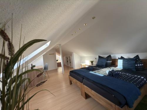 a bedroom with a large bed with blue pillows at Ferienhaus Am Schillerplatz in Eisenach
