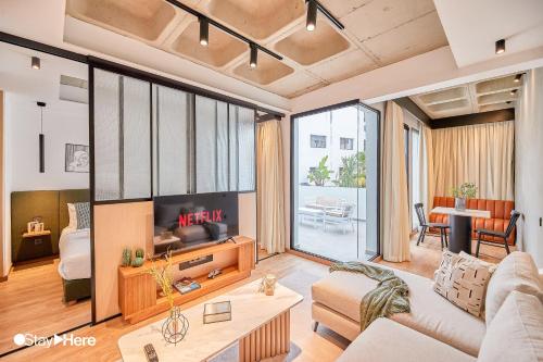 a living room with a couch and a tv at Stayhere Casablanca - Gauthier 1 - Modern Residence in Casablanca