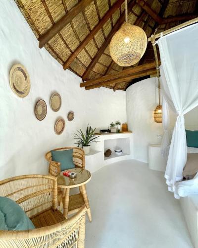 a room with chairs and a table and a ceiling at Hot spring tiny home in Limpopo in Gemsbokfontein