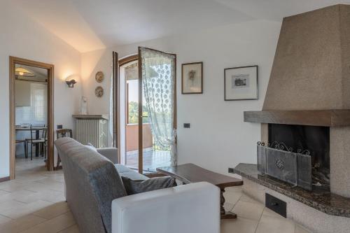 a living room with a couch and a fireplace at Casetta dei Daini in Orio al Serio