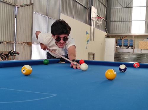 a man playing pool on a pool table at Quinta das Cantigas by Book YourHoliday PT in Aljubarrota
