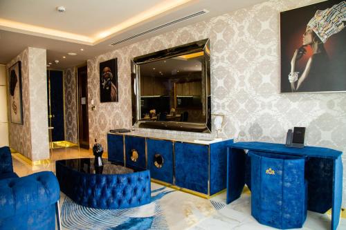 a bathroom with a blue vanity and a mirror at Number One Oxford Street Hotel & Suites in Accra