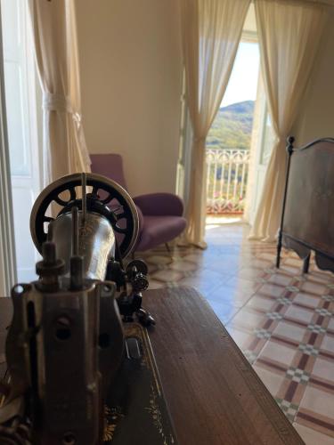 a room with a table and a chair and a window at La Dimora di Pindaro in Colledimacine