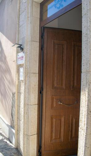 a wooden door on the side of a building at La Malvasia Apartments in Campobello di Licata