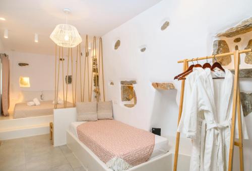 a bedroom with a bed and a bath room with a tub at Idothea guest house in Amorgos