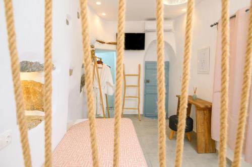 a bedroom with a bed with ropes at Idothea guest house in Amorgos
