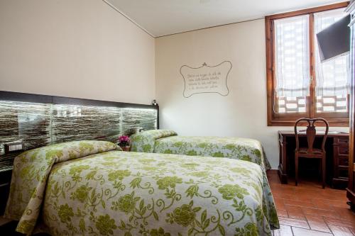 En eller flere senge i et værelse på B&B Osteria dello sperone