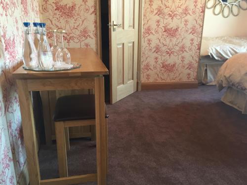 a room with a table with bottles on it at Lakeview Guest House in Stranraer