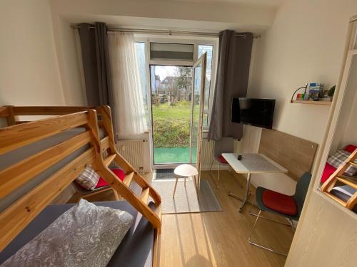 a small room with a bunk bed and a window at Ferienwohnung Tiny-Klotzsche in Dresden