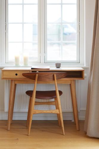 a wooden desk in front of a window at Hôtel de Ville in Gilleleje