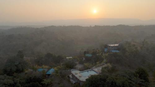 an aerial view of a house with the sunset in the background at The Sky Imperial Jungle Camp Resort in Kumbhalgarh