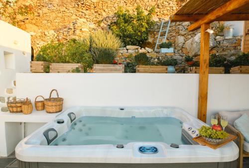 a jacuzzi tub in the middle of a garden at Idothea guest house in Amorgos