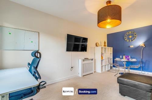 a room with a bed and a tv on a wall at 7Nights Special l Modern Apartment l Sleeps Up to 8 l Cozy 2 Bedrooms Apt By Capital Retreats Short Lets & Serviced Accommodation in Colindale With Free WIFI l Flat 4 in Colindale