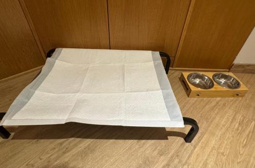 a bed with a white sheet on it in a room at Motel Soignè in Mapello