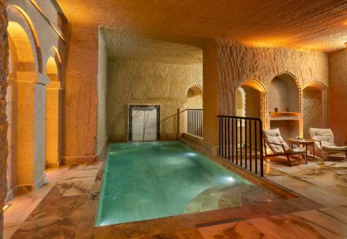 an indoor swimming pool in a building with a room with arches at Barceló Cappadocia in Nevsehir