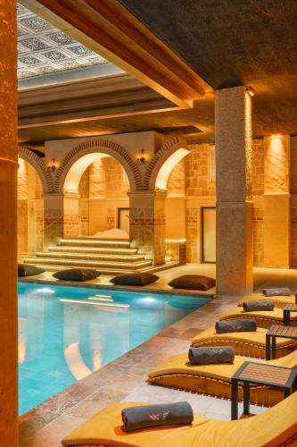 a swimming pool in a building with a hotel at Barceló Cappadocia in Nevsehir