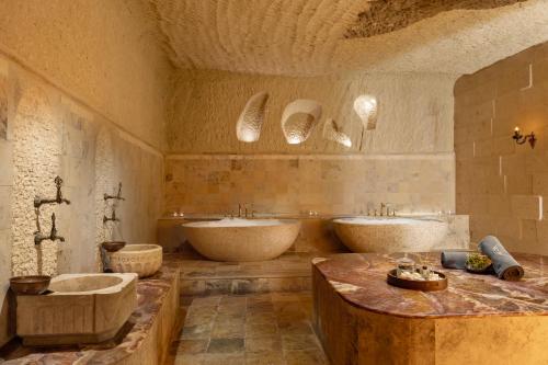 a large bathroom with two sinks and two tubs at Barceló Cappadocia in Nevsehir
