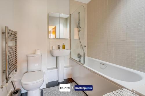 a bathroom with a toilet and a sink and a tub at 7Nights Special l Modern Apartment l Sleeps Up to 8 l Cozy 2 Bedrooms Apt By Capital Retreats Short Lets & Serviced Accommodation in Colindale With Free WIFI l Flat 4 in Colindale