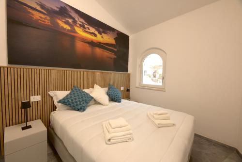 Una cama o camas en una habitación de Sardegnaexplora - Villa Sa Lumenera Ginepro