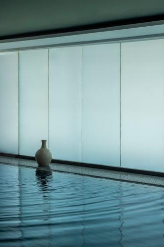 a vase sitting on the edge of a swimming pool at Sofitel Casablanca Tour Blanche in Casablanca