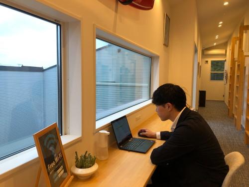 a man sitting at a desk with a laptop at SHIMAGO SURFRIDER - Vacation STAY 85442v in Amakusa