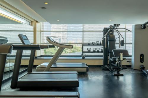 a gym with cardio equipment and a large window at Sofitel Casablanca Tour Blanche in Casablanca