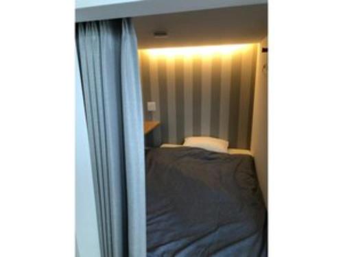 a small bedroom with a bed and a window at SHIMAGO SURFRIDER - Vacation STAY 85442v in Amakusa