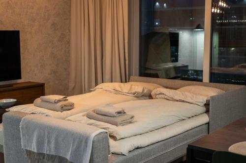 a room with two beds with towels on them at Modern 1BR Apartment with Balcony at Tripla Pasila, 5 mins to Helsinki City Center in Helsinki